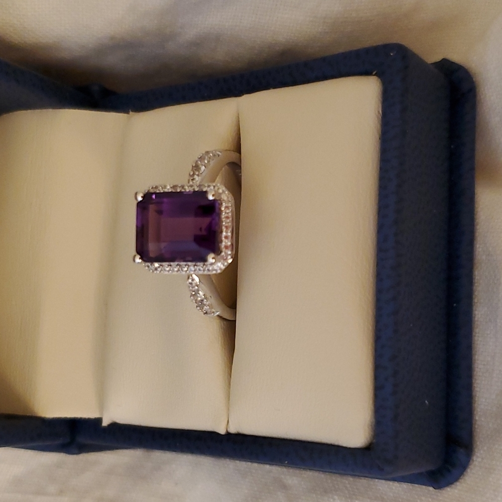 Amythist ring with a diamond halo and a few diamonds on the shank.